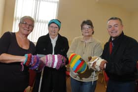 LEYLAND  05-04-17
from left, Coun Sue Jones, Halls for All volunteers Joy Mills and Louisa McFarlane and county coun Matthew Tomlinson, with Twiddle Muffs, a knitted item made to accupy the hands of dementia patients, offer information and advice at the Dementia Hub taking place with Memories Meeitng Place, at Halls for All building, Leyland.