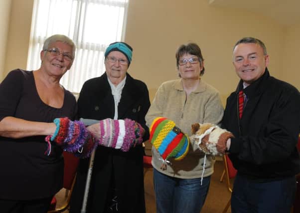 LEYLAND 05-04-17
from left, Coun Sue Jones, Halls for All volunteers Joy Mills and Louisa McFarlane and county coun Matthew Tomlinson, with Twiddle Muffs, a knitted item made to accupy the hands of dementia patients, offer information and advice at the Dementia Hub taking place with Memories Meeitng Place, at Halls for All building, Leyland.