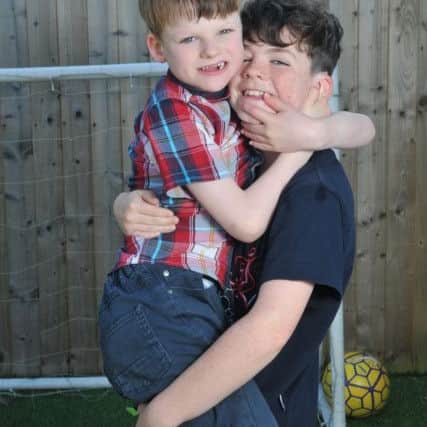 Photo Neil Cross
He ain't heavy, he's my brother ... Alex with Elliot, seven, who was born with a rare genetic disorder called Angelman Syndrome