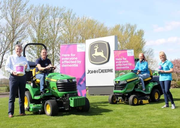 John Deere turf division manager Chris Meacock, Andy and Kathryn Maxfield, and Sue Swire of Alzheimers Society