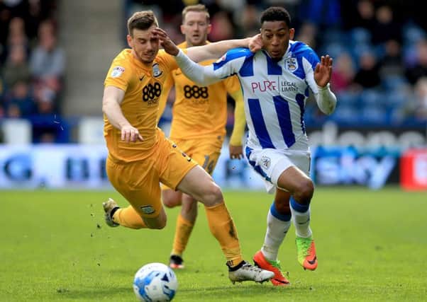 Marnick Vermijl battles with Huddersfield Town's Rajiv Van La Parra.