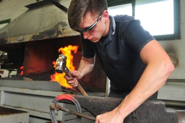 Photo: David Hurst Farrier student Raymond Higgins makes a horse shoe  at Myerscough College Open Day and Country Fair