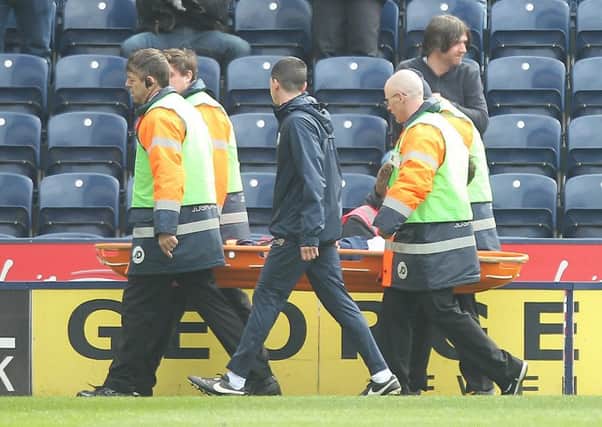 Greg Cunningham leaves the field on a stretcher after breaking his leg