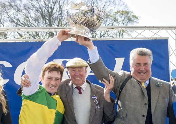 Jockey Sam Twiston-Davies (left), owner Trevor Hemmings and trainer by Paul Nicholls celebrate