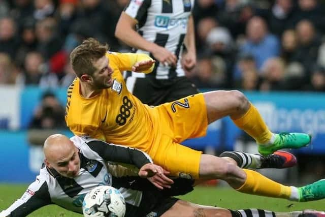 Tom Barkhuizen comes under pressure from Jonjo Shelvey.