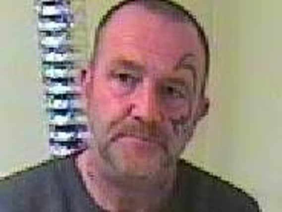 Pete Dunville has a distinctive tribal-style tattoo on the left side of his face
Pic: Lancs Police