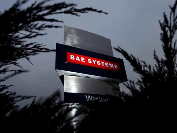 Two men have been charged with criminal damage after they allegedly gained access to the BAE Systems site at Warton, say police.