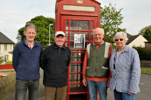 Councillors Eric Bell, Peter and Barbara Higham and Steve Fogarty in the red phone box that will be transformed into a mini library at the top of Hillside Crescent, Whittle-le-Woods