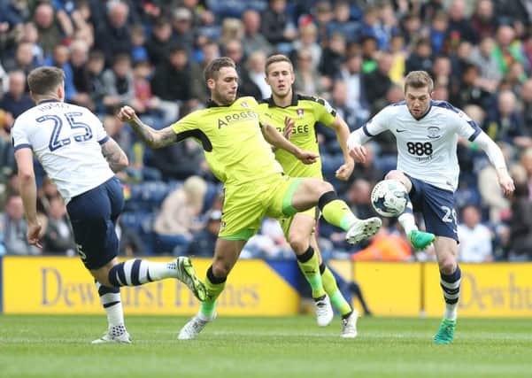 Tom Barkhuizen battles for possession against Rotherham, watched by Jordan Hugill