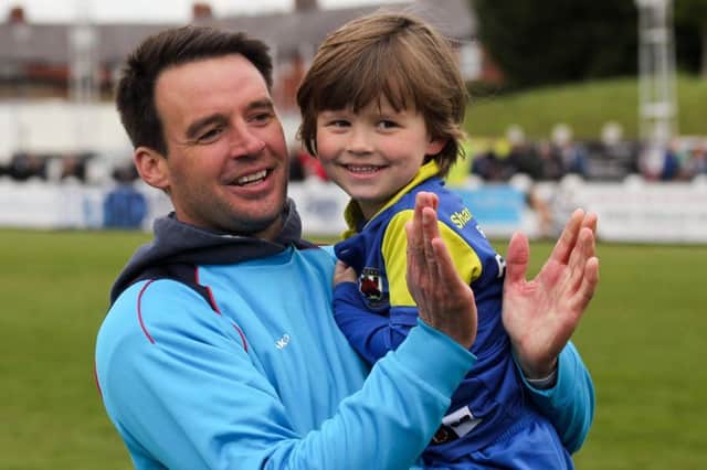 Matt Jansen celebrates claiming a play-off place with son Freddie