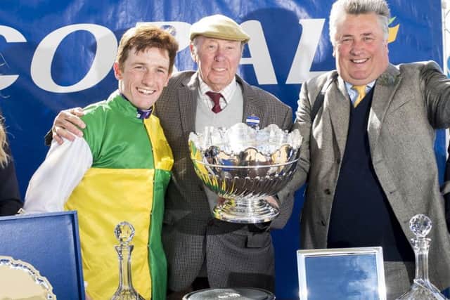 Jockey Sam Twiston-Davies (left), Owner Trevor Hemmings and trainer by Paul Nicholls celebrate after Vincente won The Coral Scottish Grand National Handicap Steeple Chase during Coral Scottish Grand National Day at Ayr Racecourse.