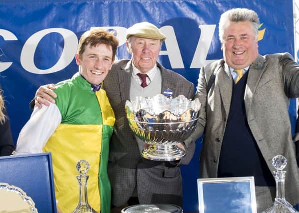 Jockey Sam Twiston-Davies (left), Owner Trevor Hemmings and trainer by Paul Nicholls celebrate after Vincente won The Coral Scottish Grand National Handicap Steeple Chase during Coral Scottish Grand National Day at Ayr Racecourse.