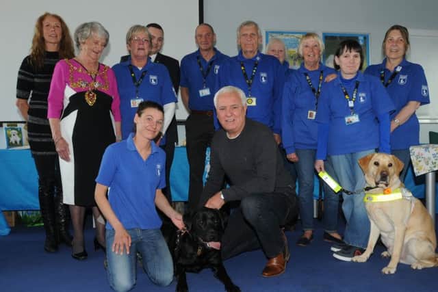 Comedian Dave Spikey, front centre, attends the celebration event as Astley (dog on the left), the guide dog puppy funded by the Chorley community, is trained and ready to be matched with someone who is blind or visually impaired, he also announced the name of a second guide dog puppy, Magpie, funded by Chorley community,  at Guide Dog Training School, Atherton.