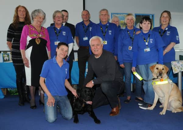 Comedian Dave Spikey, front centre, attends the celebration event as Astley (dog on the left), the guide dog puppy funded by the Chorley community, is trained and ready to be matched with someone who is blind or visually impaired, he also announced the name of a second guide dog puppy, Magpie, funded by Chorley community,  at Guide Dog Training School, Atherton.