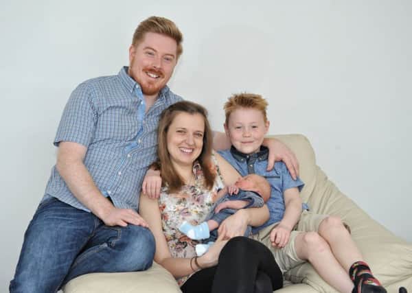 Picture by Julian Brown 06/05/17



Dad, Simon Hutton, mum Kim Chapman and brother Liam Roper, 9, pictured with baby Sebastian who was delivered by Simon on the bathroom floor of their Fulwood, Preston, home.