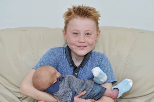 Picture by Julian Brown 06/05/17

Baby Sebastian meets big brother Liam

Dad, Simon Hutton, mum Kim Chapman and brother Liam Roper, 9, pictured with baby Sebastian who was delivered by Simon on the bathroom floor of their Fulwood, Preston, home.