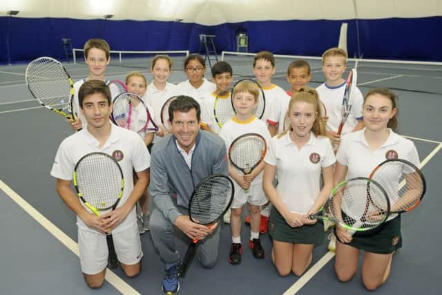 Former tennis pro Tim Henman with Stonyhurst College pupils at the opening of their new tennis centre