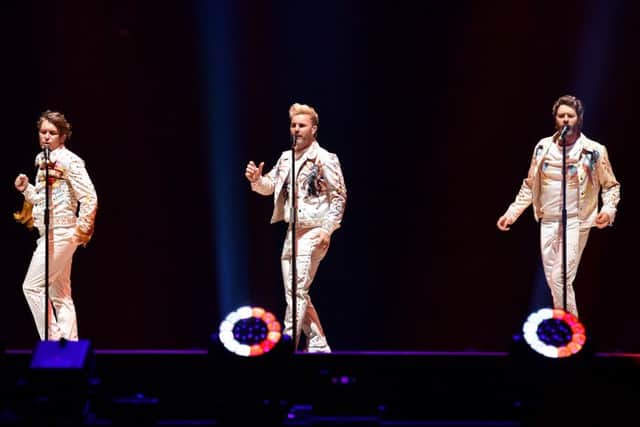 BIRMINGHAM, ENGLAND - MAY 05:  (L-R) Mark Owen, Gary Barlow and Howard Donald of Take That perform on the opening night of Wonderland Live 2017 at Genting Arena on May 5, 2017 in Birmingham, United Kingdom.  (Photo by Dave J Hogan/Dave J Hogan/Getty Images)