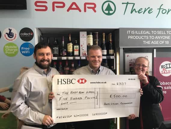 Kieron Jones, Lee Hardacre and Alison Burns from Lawrence Hunt, Penwortham head office, with a cheque for Baby Beat Appeal