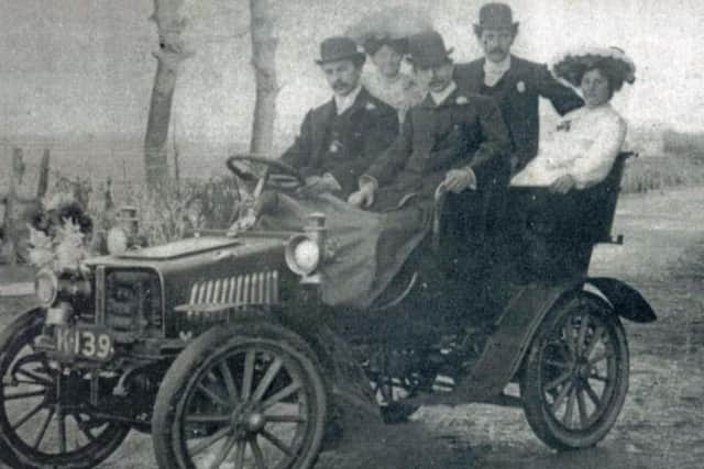 Fred Gornall off to his wedding in a car from his garage. He is in the centre of the back row, his wife Elizabeth back right, another Gornall, Albert, is driving