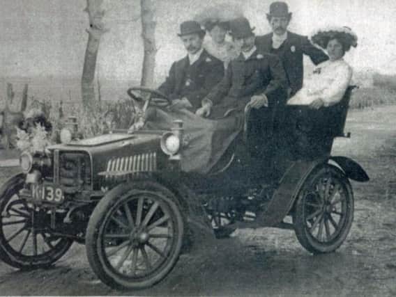 Fred Gornall off to his wedding in a car from his garage. He is in the centre of the back row, his wife Elizabeth back right, another Gornall, Albert, is driving