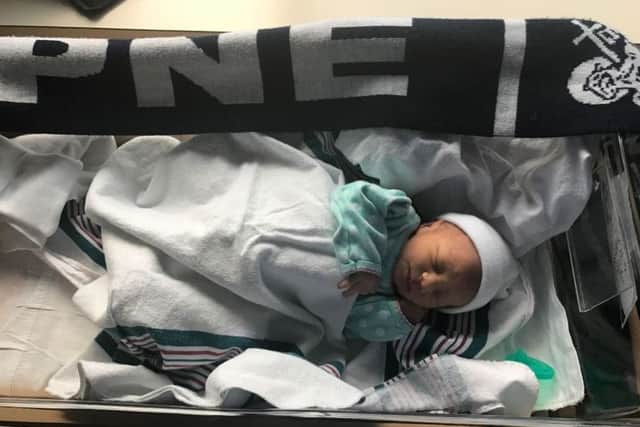 Matt Higgins' daughter Stella Lina Higgins with a Preston North End scarf at two hours old.