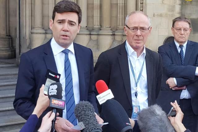Mayor of Greater Manchester Andy Burnham and Manchester City Council Leader Sir Richard Leese speak to the media outside Manchester Town Hall after a suicide bomber killed 22 people