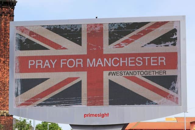 A billboard in Manchester City centre, the day after a suicide bomber killed 22 people, including children, as an explosion tore through fans leaving a pop concert in Manchester. PRESS ASSOCIATION Photo. Picture date: Tuesday May 23, 2017. See PA story POLICE Explosion. Photo credit should read: Peter Byrne/PA Wire