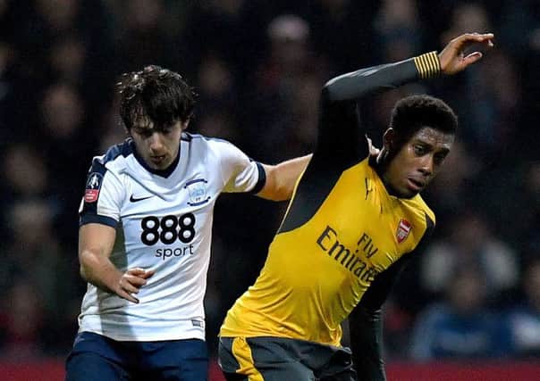 Arsenal's Alex Iwobi (right) with Ben Pearson during the Gunners' third-round victory at Preston North End