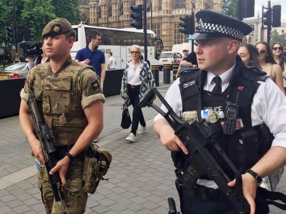 Armed police and soldiers on the streets of London