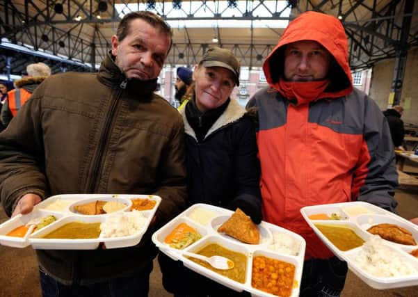 Members of the Sikh Society hold their first free food kitchen for the homeless and needy at Preston Flag Market. L-r Robert Pavionc, Laura Kay and Danny Pearson. Picture by Paul Heyes, Sunday February 26, 2017.