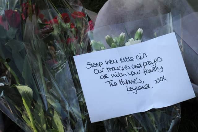 A poignant message on one of the floral tributes