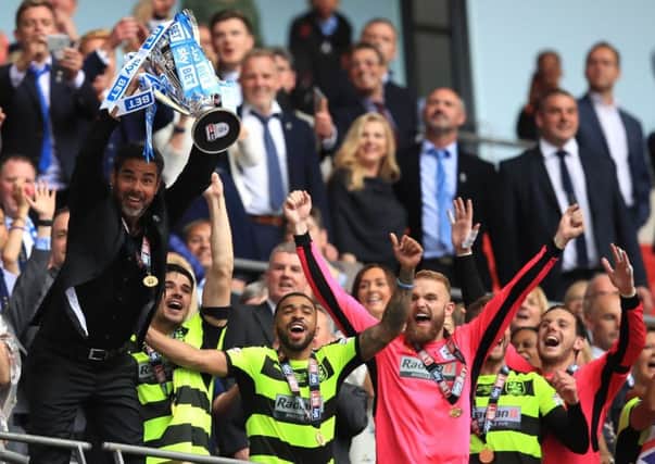 Huddersfield Town manager David Wagner lifts the trophy