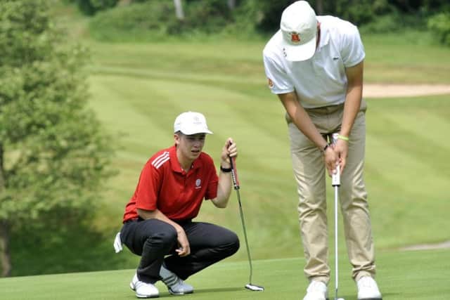 Charlie Hilton (left) watches his Spanish opponent on the greens
