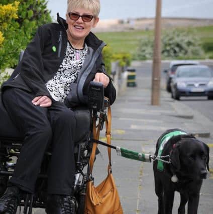 Lynn Matthews, of Longlands Avenue in Heysham, is disabled and is helped in her day-to-day life by her assistance dog Christa, a black labrador.
Lynn and Christa off out for a walk.  PIC BY ROB LOCK
9-5-2017