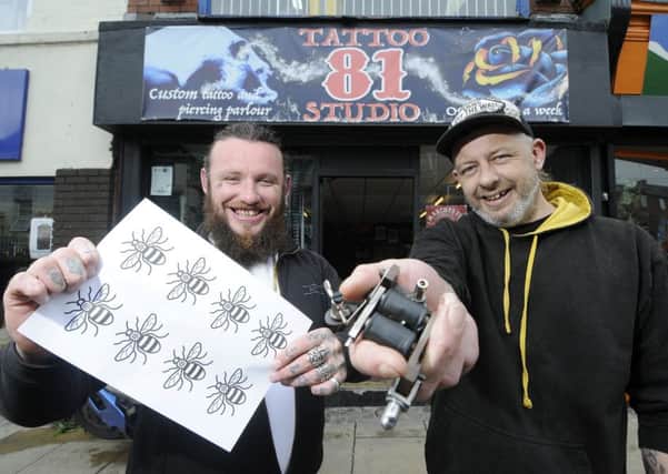 Studio 81 are doing bee tattoos for the Manchester appeal.  Pictured is manager Steve Heery and tattooist Stu Nellas.