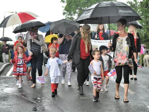 The procession braves heavy rain last year
