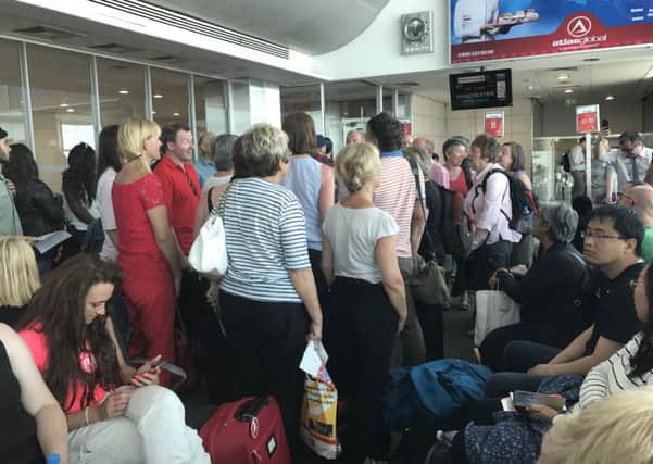 The singers break into song at the airport gate