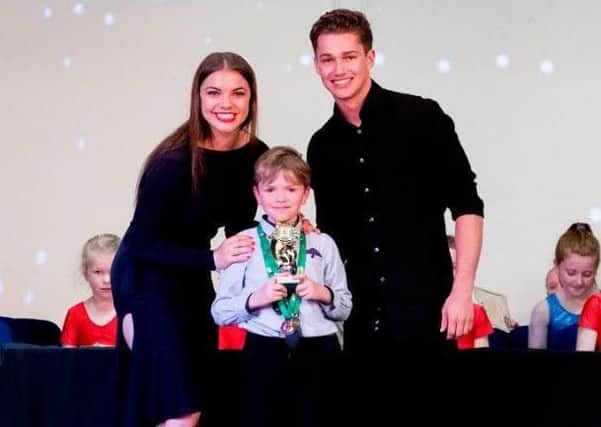 Andrew Bradshaw, Paula Boscott School of Dance, receiving outstanding achievement award from Strictly Come Dancers performers AJ Pritchard and Chloe Hewitt.