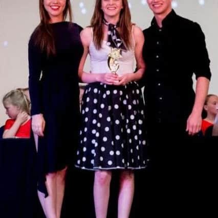 Lucy Dowson, from Paula Boscott School of Dance, receiving outstanding achievement award from Strictly Come Dancers performers AJ Pritchard and Chloe Hewitt.