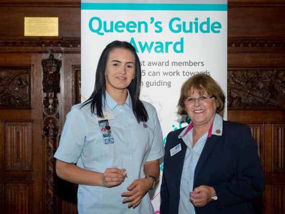 Girl Guide Adele Collier, 25, from Chorley Adele with deputy chief guide Sally Illsley. Adele has received the Queen's Guide Award