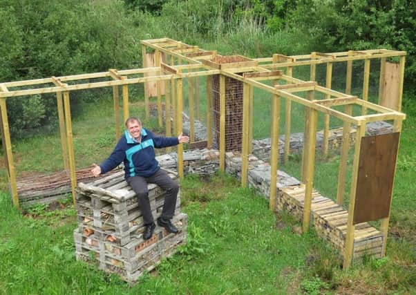 Martin Mere centre manager Nick Brooks with the new 'bug hotel'