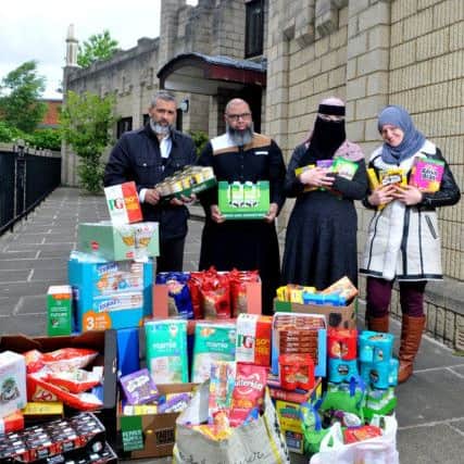 Photo Neil Cross
Ilyas Esmail, Saeed Atcha, Sofia Begum-Ali and Sara Suleman at Jamea Masjid mosque on Clarendon Street, Preston with a small portion of the  food they have collected for the Salvation Army food bank