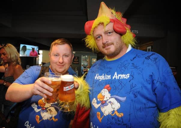 Two members of staff from the Hoghton Arms pub in Withnell took part in a 'chicken run' -a hitch hike from Portugal back to the pub- to raise funds for Derian House, ending  in a family fun day.
Having just arrived back, Will Ferguson (left) and James Hamilton prepare to down their first pint.  PIC BY ROB LOCK
18-6-2017