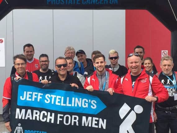 Martin Booker and Courtney Bushell from the Fleetwood Town Commercial Team help get Jeff Stelling under way on the tenth leg of his March for Men, from Highbury to the Globe Arena