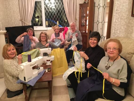 Members of Soroptimist International Preston sewing dresses out of pillow cases for girls in third world countries