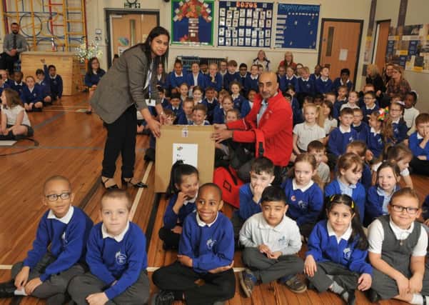 Photo Neil Cross
Postie Asim Raza delivers a surprise gift to Azra Butt of Eldon Primary School