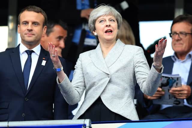 Prime Minister Theresa May alongside French President Emmanuel Macron during the International Friendly at the Stade de France, Paris. PRESS ASSOCIATION Photo. Picture date: Tuesday June 13, 2017. See PA story SOCCER France. Photo credit should read: Mike Egerton/PA Wire. RESTRICTIONS: Use subject to FA restrictions. Editorial use only. Commercial use only with prior written consent of the FA. No editing except cropping.