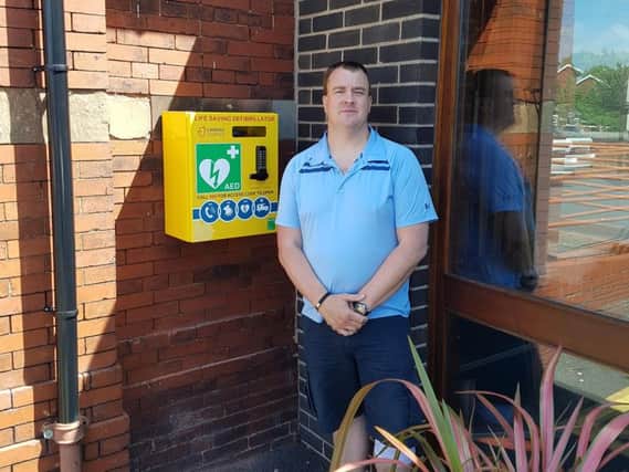 Russ Waring, church warden of St Johns Parish Church, with the new defibrillator