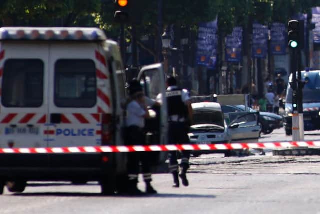 Police forces secure the area on the Champs Elyses next to the suspected car